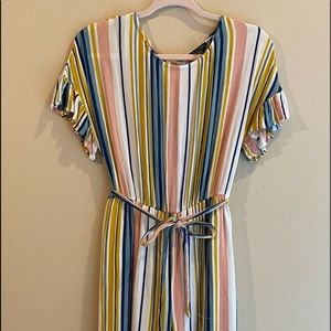 One piece jumper. Buttons in the back. Has light lining around the panty area.